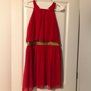 Red layered dress with gold accent belt
